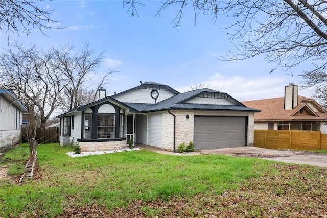 single story home featuring fence, a front lawn, concrete driveway, an attached garage, and a shingled roof