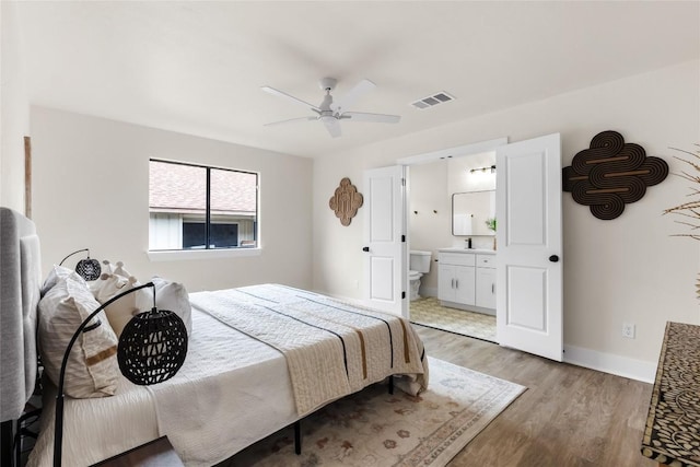 927 Peggotty Pl, Austin, TX 78753 - bedroom featuring light wood-type flooring, ensuite bath, baseboards, a sink, and a ceiling fan
