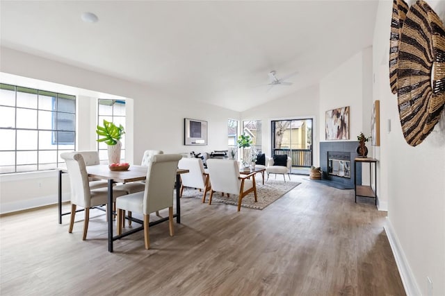 927 Peggotty Pl, Austin, TX 78753 - dining space with wood finished floors, ceiling fan, lofted ceiling, and a fireplace