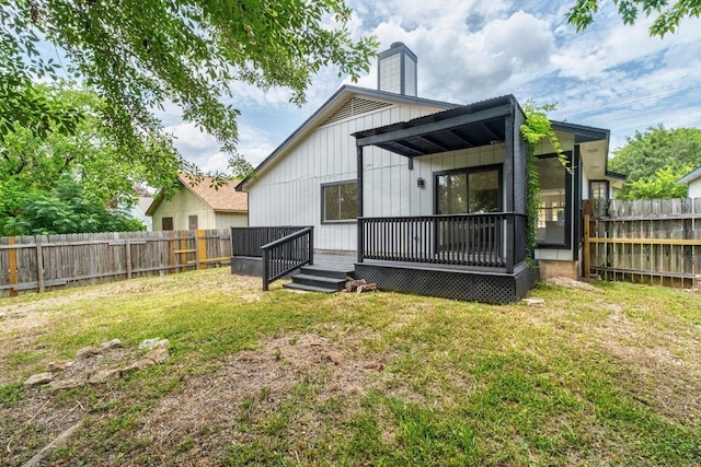 927 Peggotty Pl, Austin, TX 78753 - back of house featuring a fenced backyard, a wooden deck, and a chimney