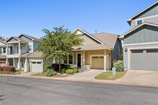 view of front of home with a garage, board and batten siding, driveway, and a shingled roof