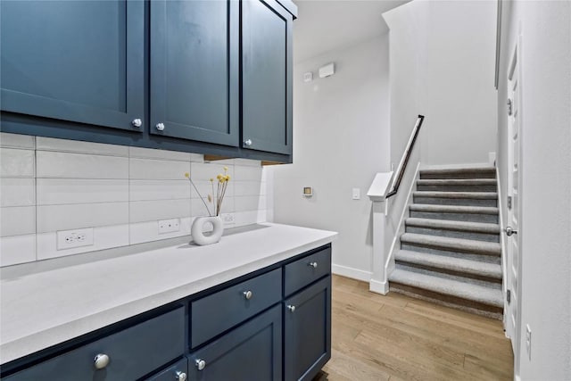 interior space with baseboards and light wood finished floors