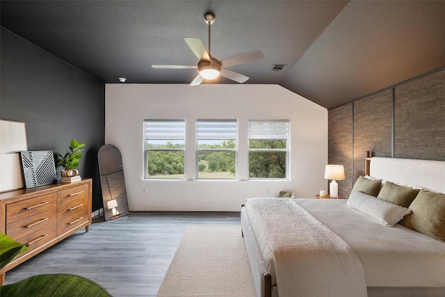 16720 Horondelle Dr, Austin, TX 78738 - bedroom featuring wood finished floors, lofted ceiling, and a ceiling fan