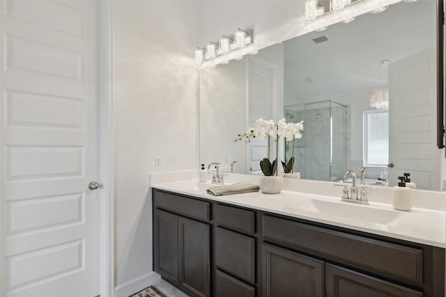 16720 Horondelle Dr, Austin, TX 78738 - bathroom featuring a shower stall, double vanity, and a chandelier