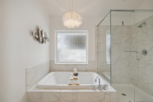 16720 Horondelle Dr, Austin, TX 78738 - bathroom featuring a garden tub, a chandelier, and a stall shower