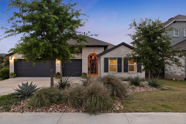 16720 Horondelle Dr, Austin, TX 78738 - view of front of property with brick siding, driveway, and an attached garage