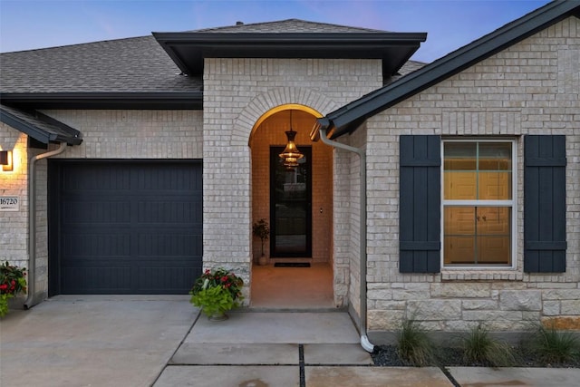 16720 Horondelle Dr, Austin, TX 78738 - entrance to property with driveway, a garage, a shingled roof, and brick siding