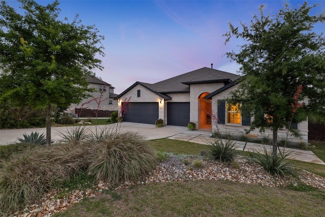 16720 Horondelle Dr, Austin, TX 78738 - view of front of house with a garage, concrete driveway, a front yard, stone siding, and brick siding