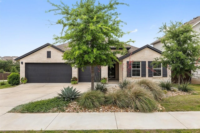 16720 Horondelle Dr, Austin, TX 78738 - view of front of house featuring driveway, a garage, and brick siding