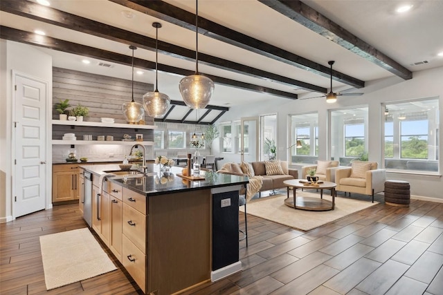 16720 Horondelle Dr, Austin, TX 78738 - kitchen with dark wood finished floors, light brown cabinets, a breakfast bar area, open floor plan, and beamed ceiling
