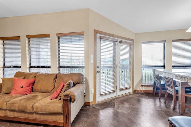 living room with baseboards and finished concrete floors