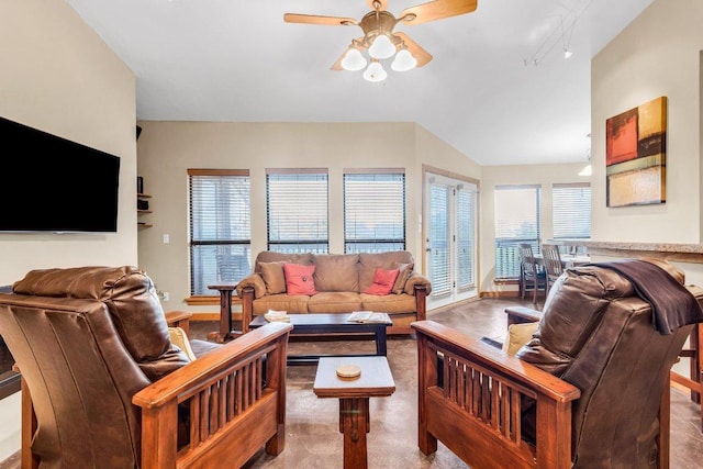 living area with baseboards, a ceiling fan, and carpet flooring