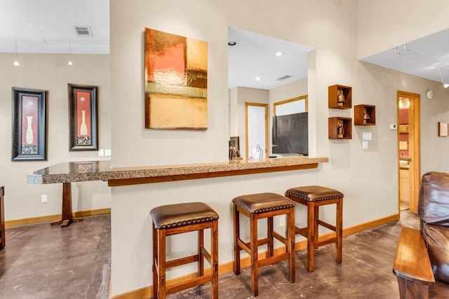 bar with baseboards, freestanding refrigerator, concrete floors, and visible vents