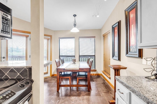 dining area with baseboards, concrete floors, and a wealth of natural light