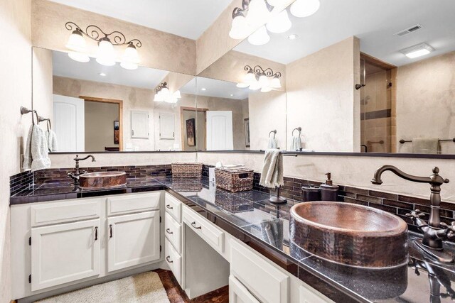 1406 Windsor Rd Unit 305, Austin, TX 78703 - full bathroom with decorative backsplash, double vanity, and a tile shower