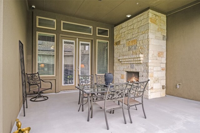 view of patio / terrace with an outdoor stone fireplace and outdoor dining area