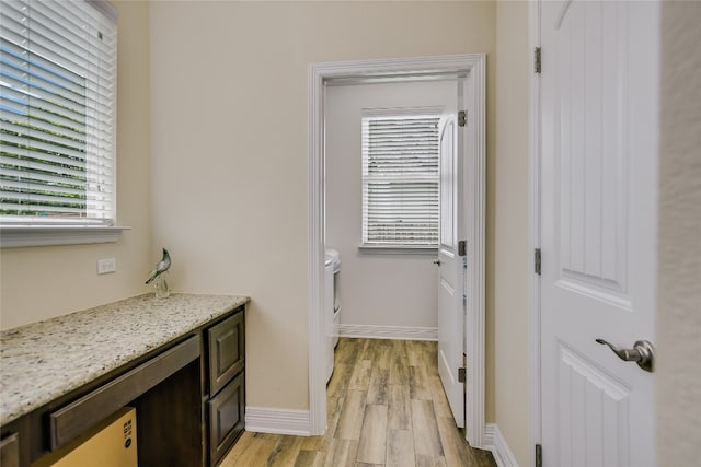 18104 Monarch Butterfly Way, Pflugerville, TX 78660 - laundry area featuring light wood-style flooring and baseboards
