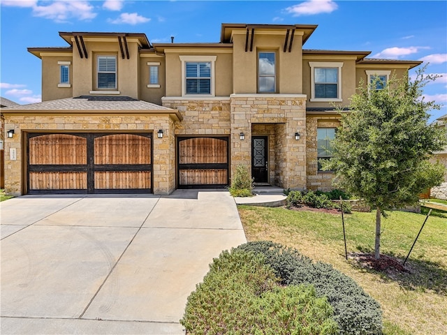 view of front facade with a garage, a front lawn, stone siding, stucco siding, and driveway