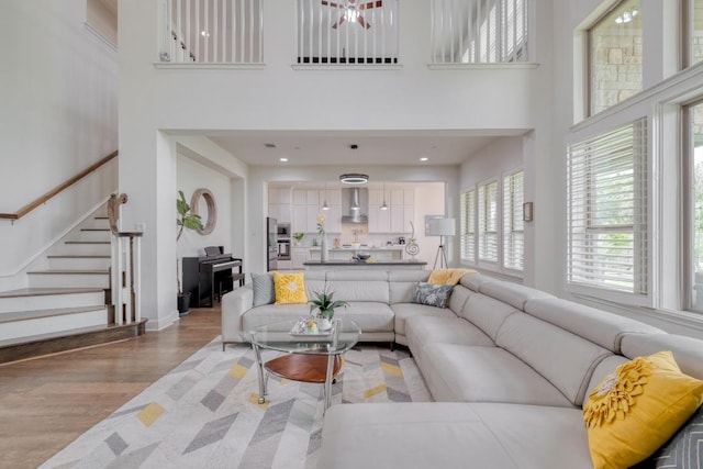 3908 Logan Ridge Dr, Cedar Park, TX 78613 - living room with a high ceiling, light wood-style floors, and stairs