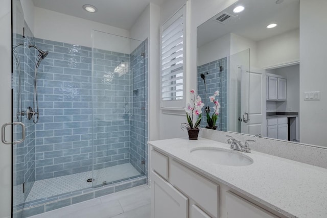 3908 Logan Ridge Dr, Cedar Park, TX 78613 - bathroom featuring a shower stall, tile patterned floors, vanity, and recessed lighting