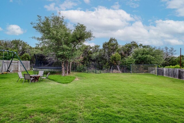3908 Logan Ridge Dr, Cedar Park, TX 78613 - fenced backyard with a trampoline and view of scattered trees