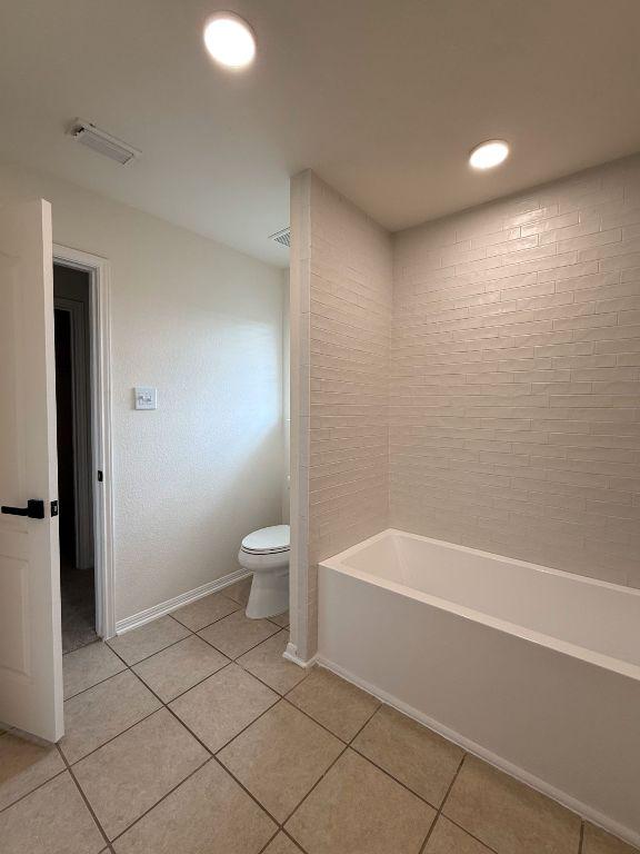 full bath featuring tile patterned flooring, toilet, and visible vents