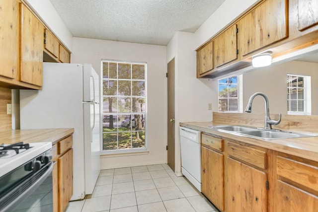 11948 Sunhillow Bnd Unit A & B, Austin, TX 78758 - kitchen featuring a sink, white appliances, light countertops, a textured ceiling, and healthy amount of natural light