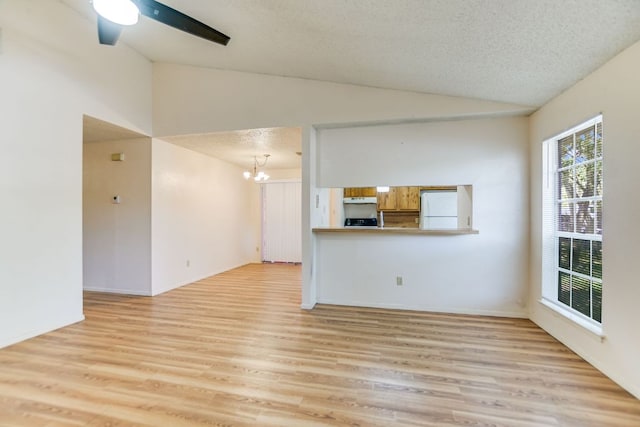 11948 Sunhillow Bnd Unit A & B, Austin, TX 78758 - unfurnished living room with lofted ceiling, a chandelier, light wood finished floors, a ceiling fan, and a textured ceiling