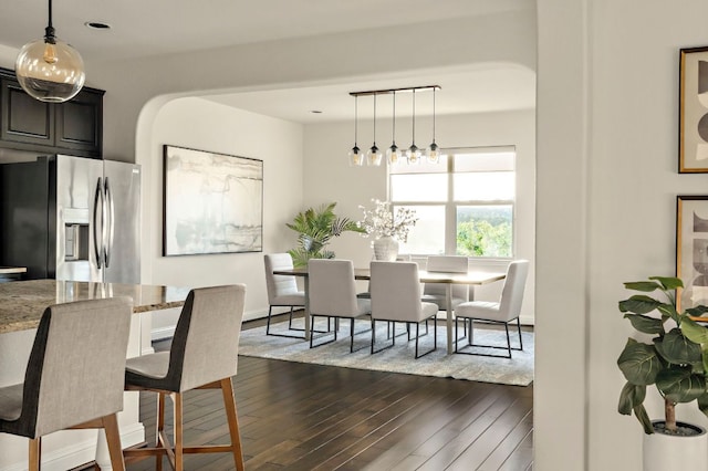 dining room featuring a notable chandelier and dark wood-type flooring