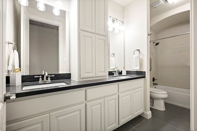 full bathroom with a sink, tile patterned floors, toilet, and visible vents