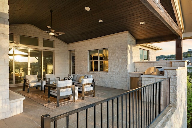 view of patio featuring an outdoor living space, a grill, ceiling fan, and an outdoor kitchen