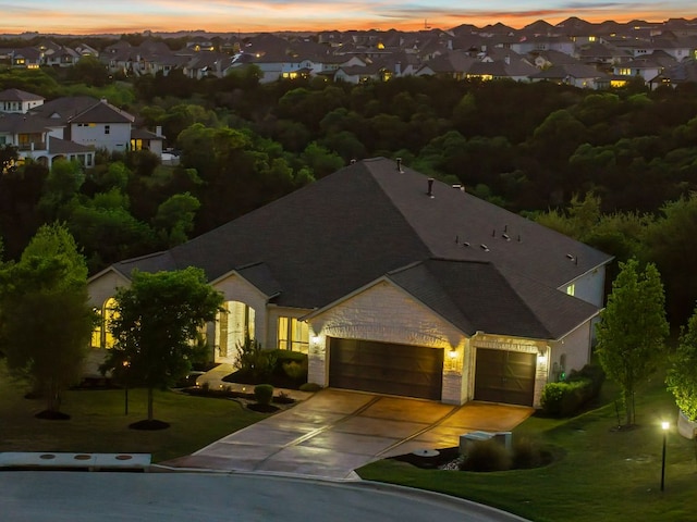 aerial view at dusk featuring a residential view