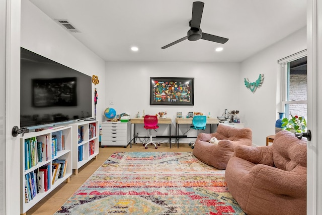 living area with a ceiling fan, recessed lighting, and visible vents