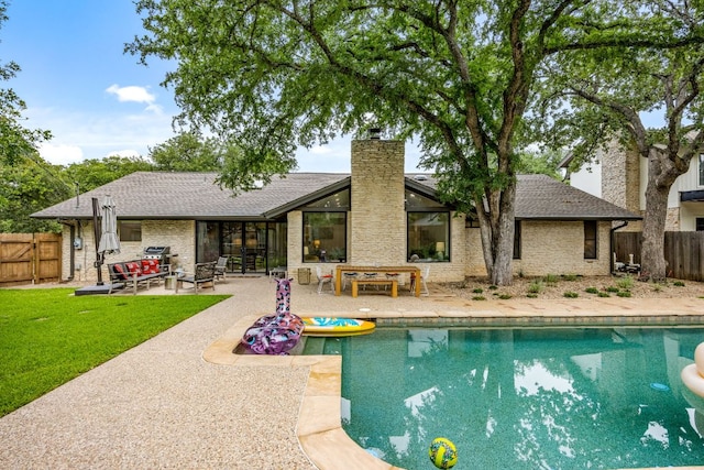 view of pool featuring a fenced backyard, a fenced in pool, a lawn, and a patio area