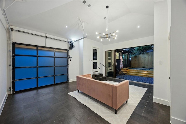 living room featuring visible vents, baseboards, a chandelier, and vaulted ceiling