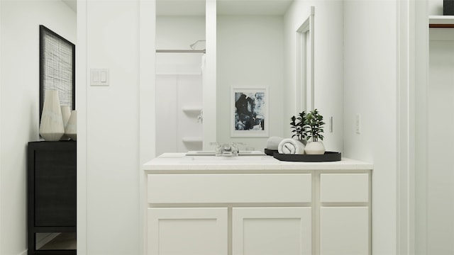 bathroom featuring walk in shower and vanity