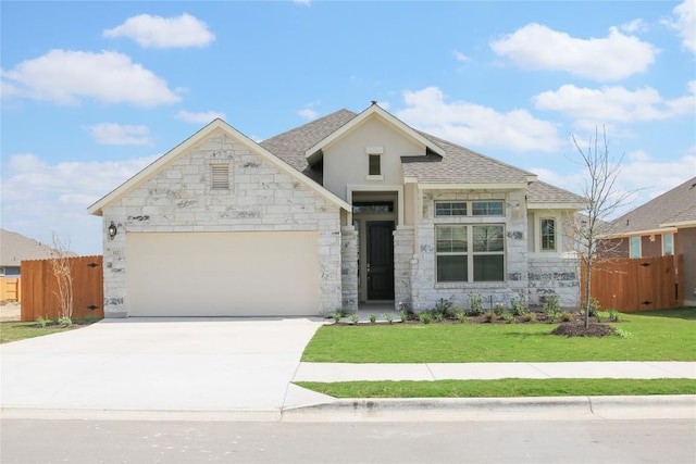 148 Golden Sage Ave, Georgetown, TX 78633 - view of front of property with an attached garage, driveway, stone siding, and roof with shingles