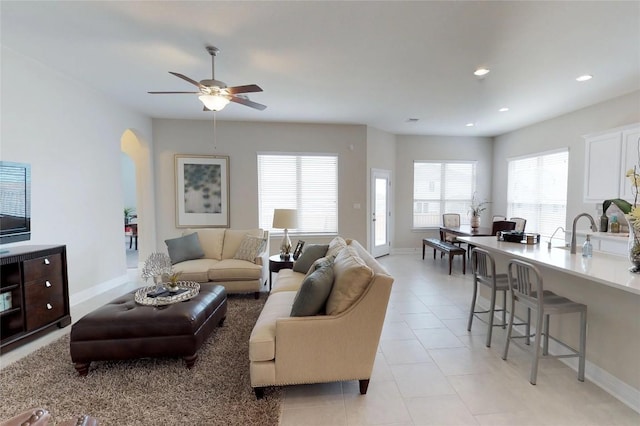 148 Golden Sage Ave, Georgetown, TX 78633 - living area featuring plenty of natural light, ceiling fan, arched walkways, recessed lighting, and light tile patterned flooring
