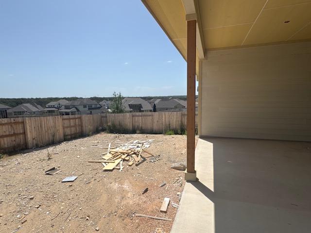 148 Golden Sage Ave, Georgetown, TX 78633 - fenced backyard with a patio area and a residential view