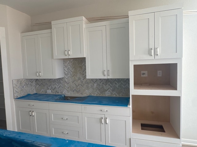 148 Golden Sage Ave, Georgetown, TX 78633 - kitchen featuring tasteful backsplash, open shelves, black electric stovetop, and white cabinetry