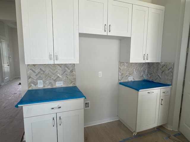 148 Golden Sage Ave, Georgetown, TX 78633 - kitchen featuring decorative backsplash, white cabinets, and light wood-style flooring