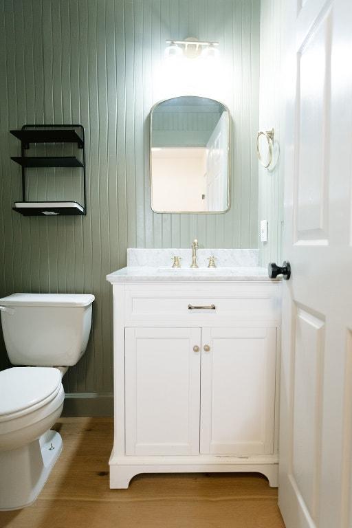 5711 Steven Creek Way, Austin, TX 78721 - bathroom featuring vanity, wood finished floors, and toilet