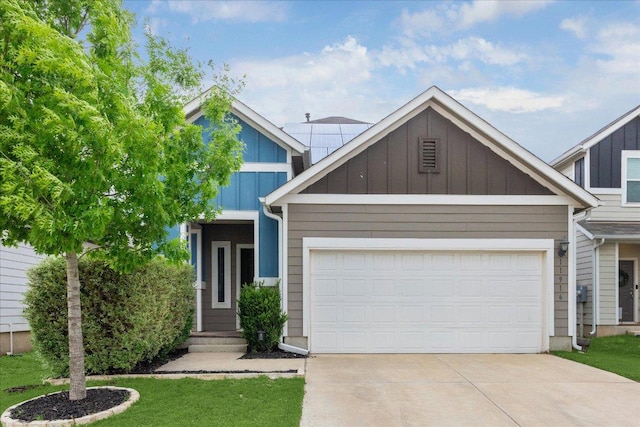 view of front of property featuring an attached garage, board and batten siding, and concrete driveway