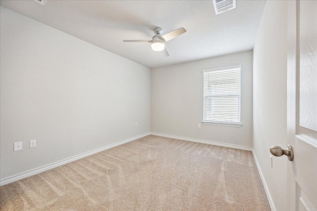 unfurnished room with a ceiling fan, baseboards, visible vents, and carpet