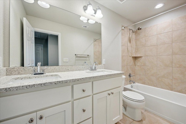 full bath with visible vents, a sink, shower / bathtub combination, and toilet