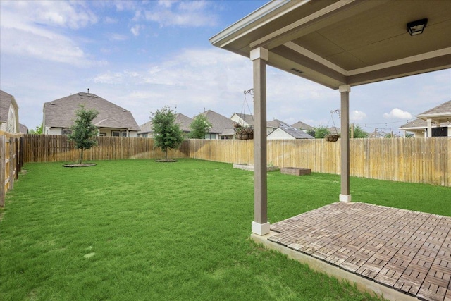 view of yard featuring a fenced backyard, a patio area, and a residential view