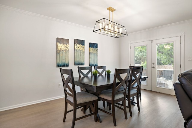 2104 Faldo Ln, Round Rock, TX 78664 - dining area featuring crown molding, wood finished floors, french doors, baseboards, and a chandelier