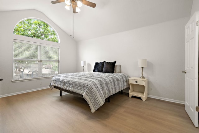 2104 Faldo Ln, Round Rock, TX 78664 - bedroom with lofted ceiling, wood finished floors, baseboards, and a ceiling fan