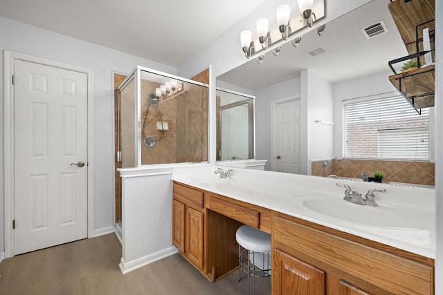 2104 Faldo Ln, Round Rock, TX 78664 - full bath with wood finished floors, a stall shower, double vanity, and baseboards