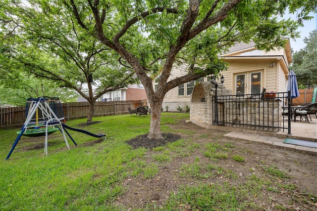 2104 Faldo Ln, Round Rock, TX 78664 - view of yard featuring a patio area, french doors, and a playground